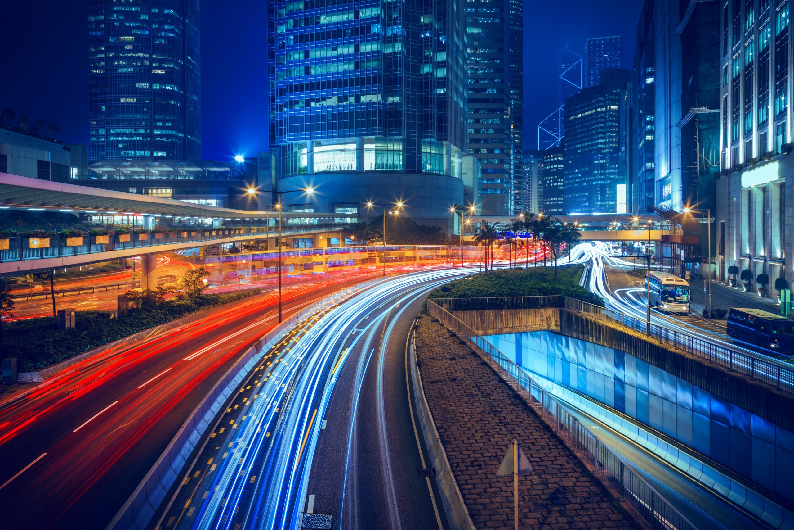 Cars travelling through a city at night, taken on a camera with a slow shutter speed.